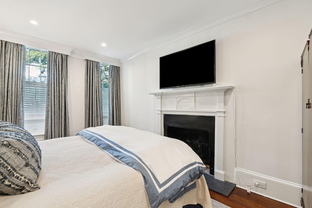 bedroom featuring ornamental molding and dark hardwood / wood-style floors