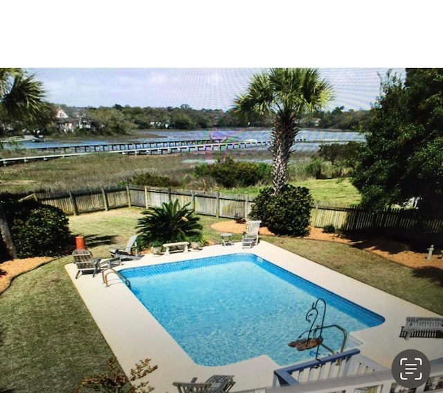 view of swimming pool with a yard