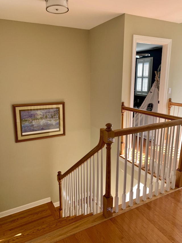 stairs featuring hardwood / wood-style flooring