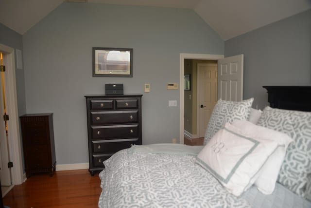 bedroom featuring vaulted ceiling and dark hardwood / wood-style floors