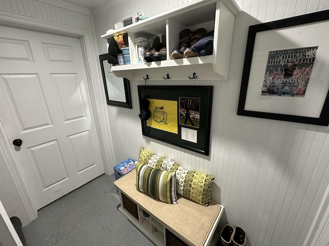 mudroom featuring wooden walls