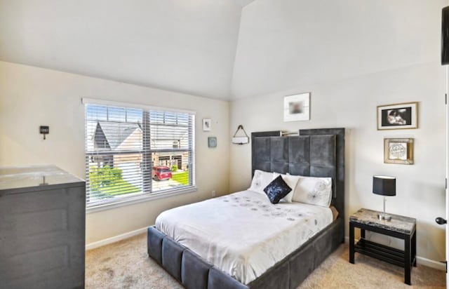 carpeted bedroom featuring high vaulted ceiling