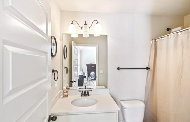 bathroom featuring toilet and large vanity