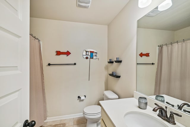 bathroom with toilet, oversized vanity, and tile flooring