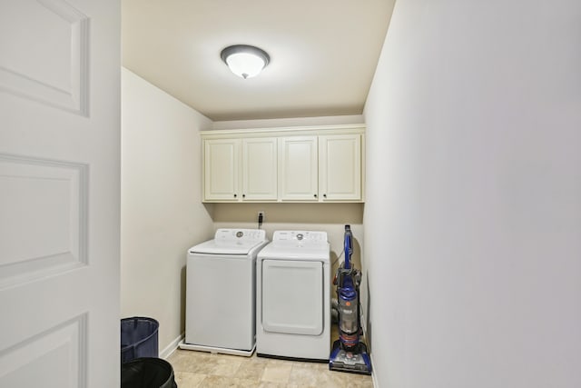 laundry room featuring cabinets, separate washer and dryer, and light tile floors