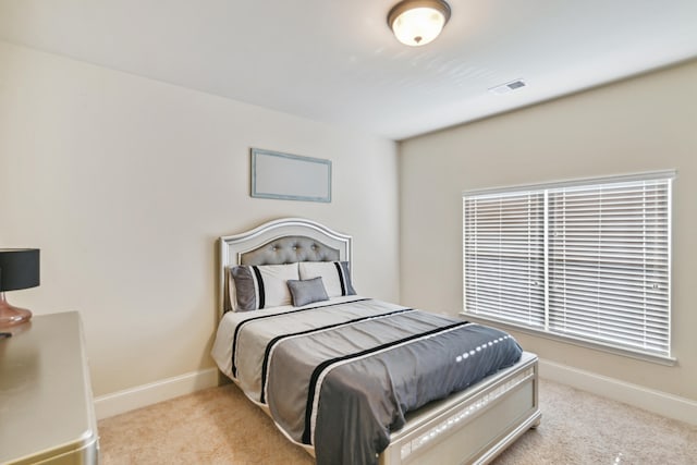 bedroom featuring light carpet