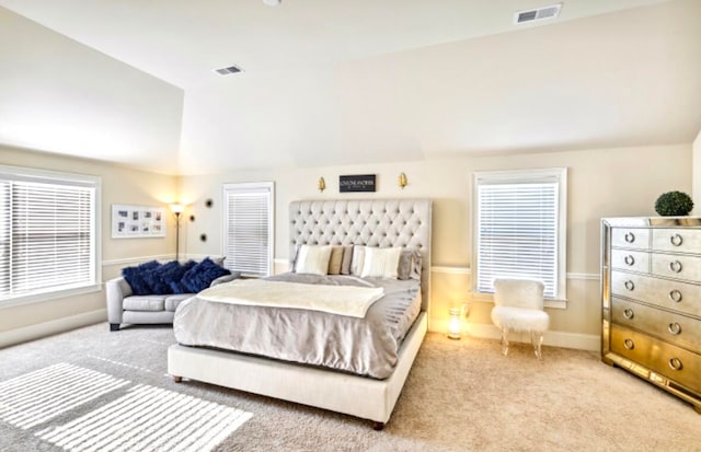 bedroom with lofted ceiling and light colored carpet