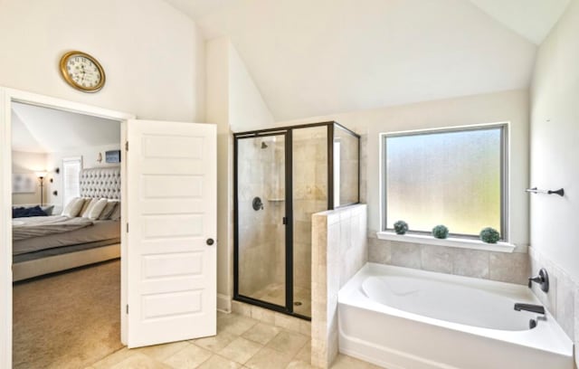 bathroom with separate shower and tub, vaulted ceiling, and tile flooring