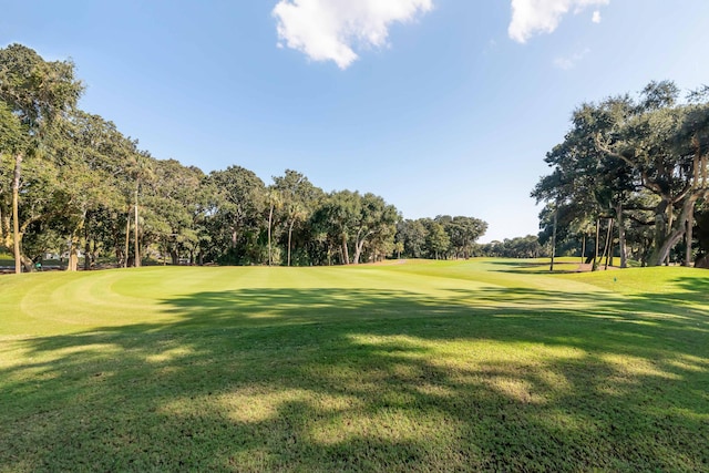 view of home's community with a lawn and golf course view