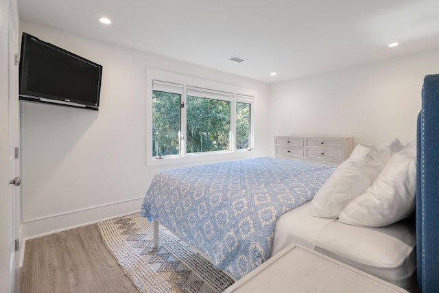 bedroom featuring recessed lighting, wood finished floors, and visible vents
