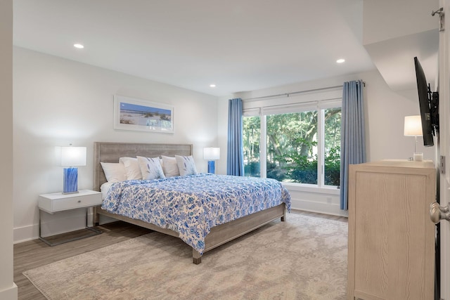 bedroom with baseboards, recessed lighting, and wood finished floors