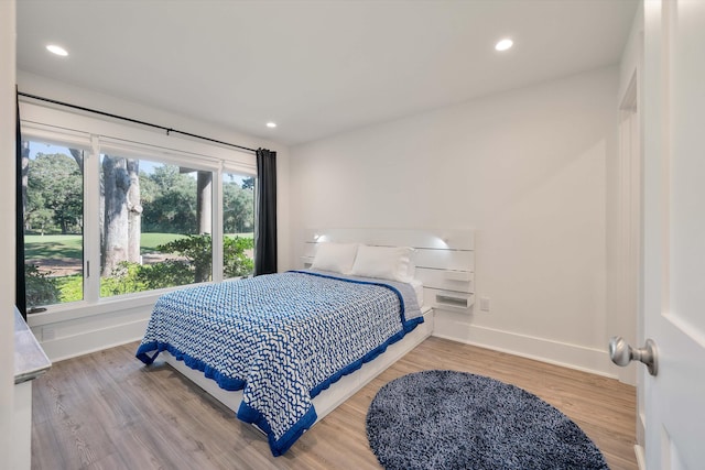 bedroom with recessed lighting, baseboards, and wood finished floors