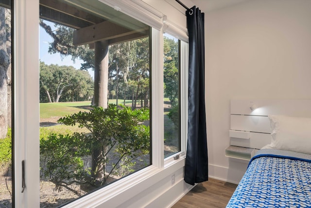 bedroom featuring baseboards and wood finished floors