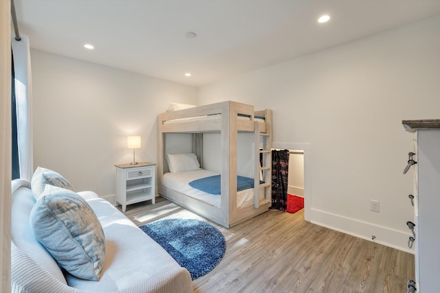 bedroom featuring light wood-type flooring, recessed lighting, and baseboards
