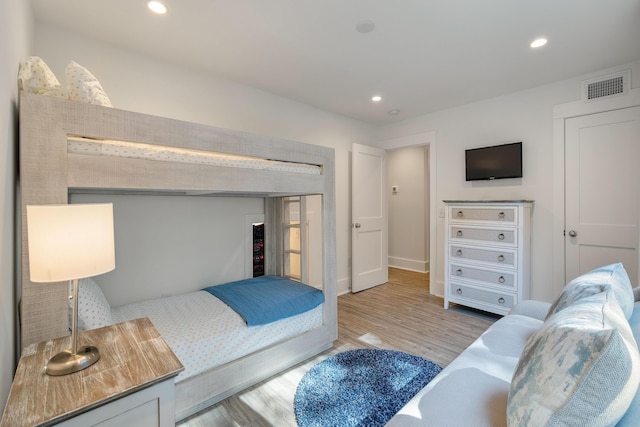 bedroom featuring baseboards, recessed lighting, light wood-style flooring, and visible vents