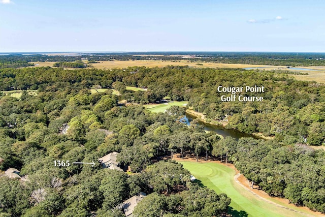 birds eye view of property featuring view of golf course and a wooded view