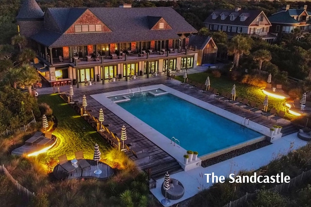 pool with a fire pit and a patio area