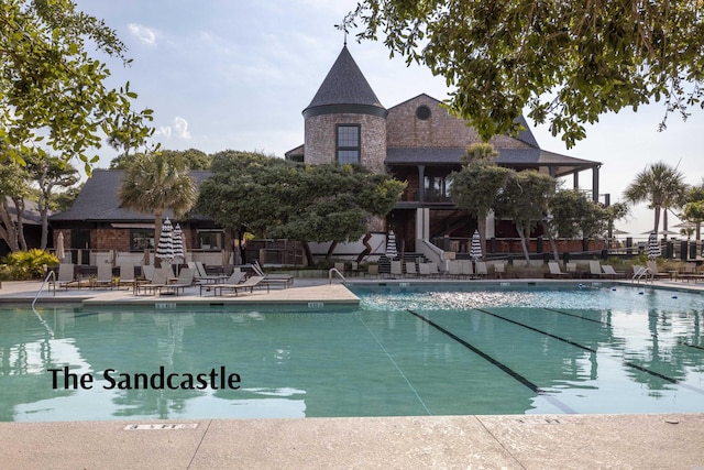 pool with fence and a patio