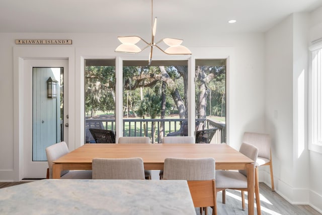 dining area with baseboards, recessed lighting, and wood finished floors