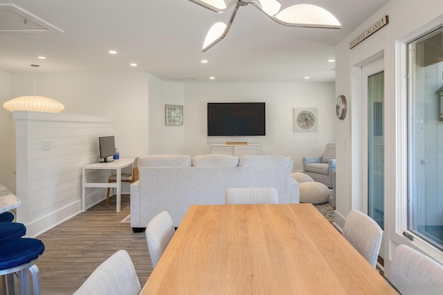 dining area featuring baseboards, attic access, recessed lighting, and wood finished floors