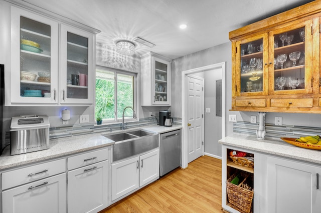 kitchen featuring dishwasher, white cabinets, light hardwood / wood-style flooring, and sink