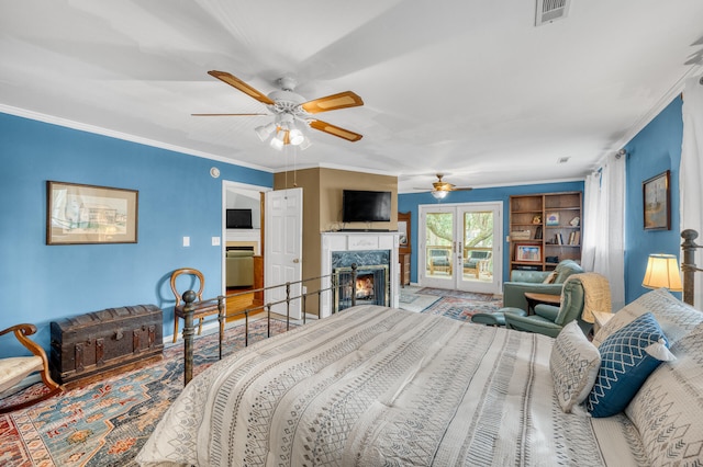 bedroom with ceiling fan, crown molding, and a high end fireplace