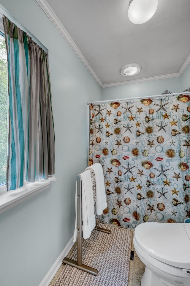 bathroom featuring tile patterned floors, toilet, and crown molding