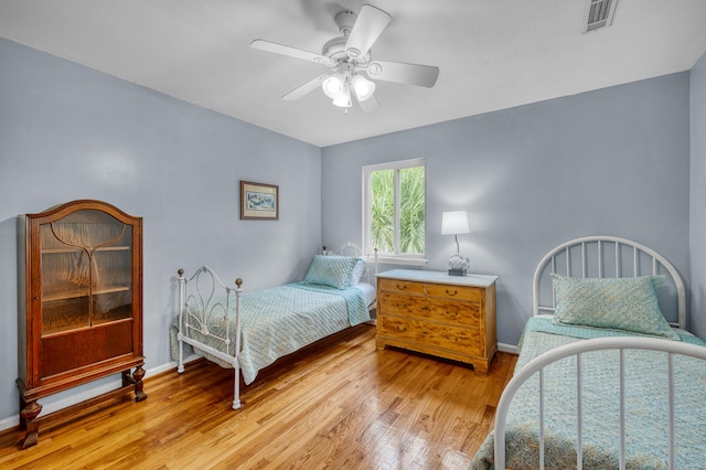 bedroom with ceiling fan and light wood-type flooring