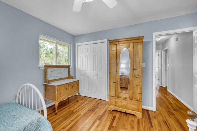 bedroom featuring ceiling fan, light hardwood / wood-style floors, and a closet