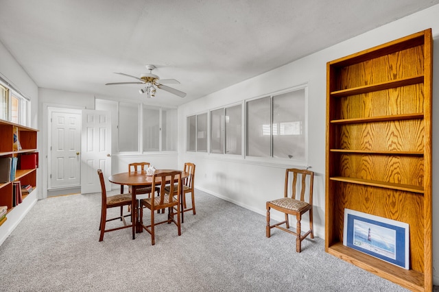 dining area with ceiling fan, carpet floors, and built in shelves