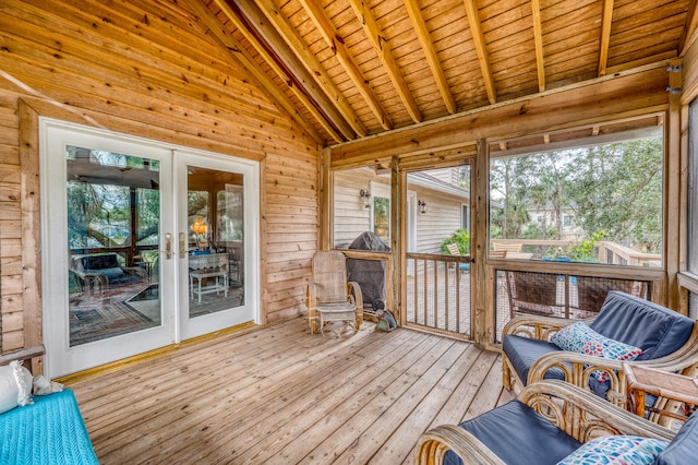 sunroom / solarium with vaulted ceiling with beams, wooden ceiling, and a healthy amount of sunlight