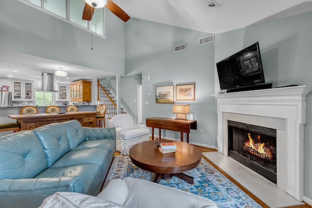 living room featuring high vaulted ceiling and ceiling fan