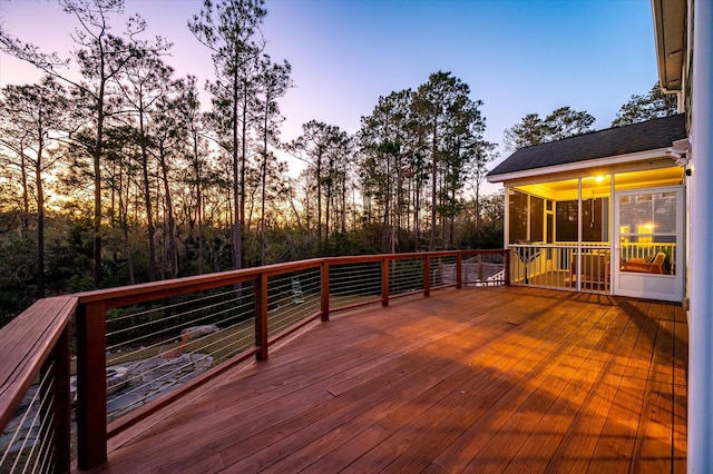 wooden deck with a sunroom