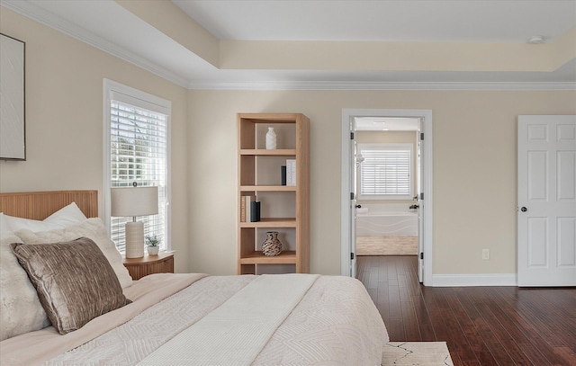 bedroom featuring a tray ceiling, dark wood-type flooring, baseboards, and ornamental molding