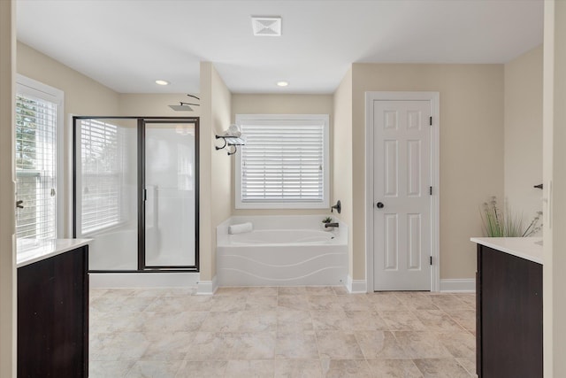 bathroom with vanity, baseboards, visible vents, a shower stall, and a bath