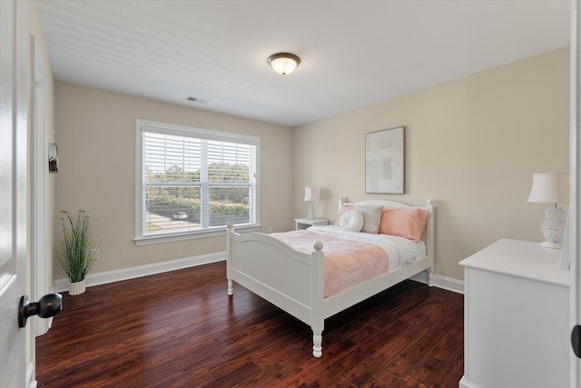 bedroom with visible vents, baseboards, and dark wood-style floors