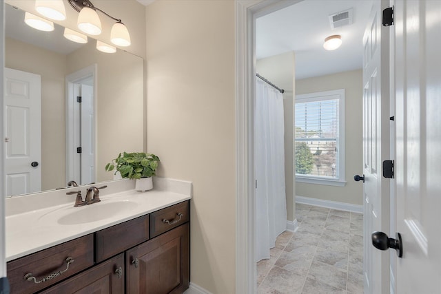 full bathroom with visible vents, baseboards, and vanity