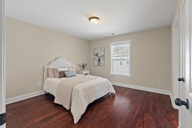 bedroom with visible vents, baseboards, and dark wood-style flooring