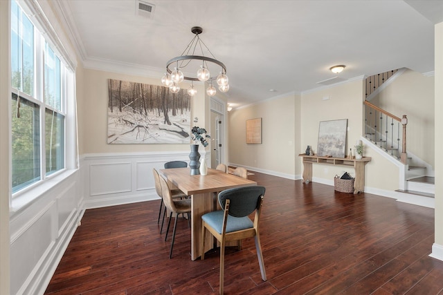 dining area featuring visible vents, crown molding, dark wood-type flooring, a chandelier, and stairs