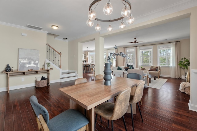 dining room featuring visible vents, ornamental molding, stairs, and hardwood / wood-style flooring