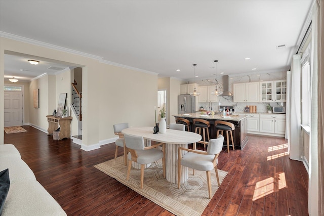 dining room featuring stairway, baseboards, dark wood-style flooring, and ornamental molding