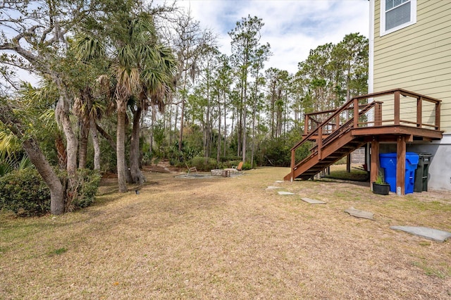 view of yard with stairs and a deck