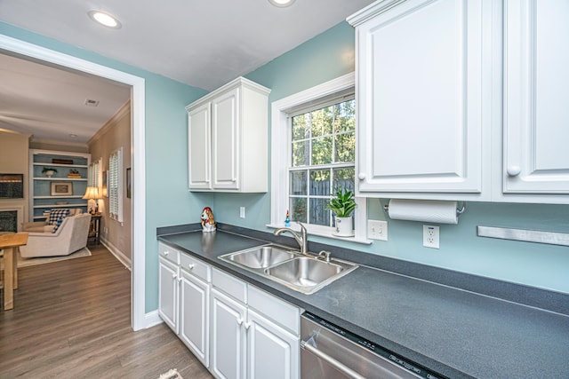 kitchen with sink, light hardwood / wood-style flooring, stainless steel dishwasher, and white cabinets