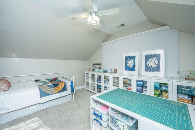 carpeted bedroom with ceiling fan and vaulted ceiling