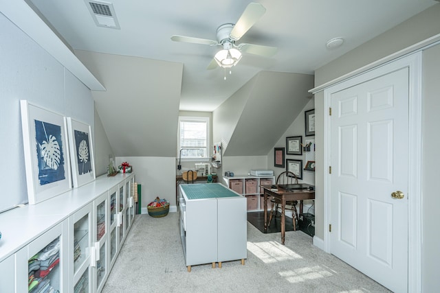 home office featuring ceiling fan, light colored carpet, and vaulted ceiling