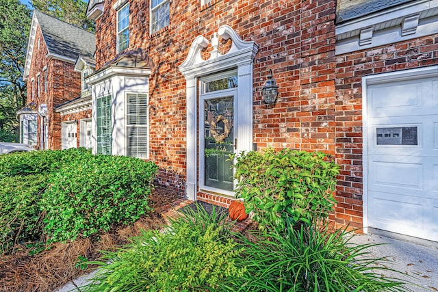 view of exterior entry with a garage