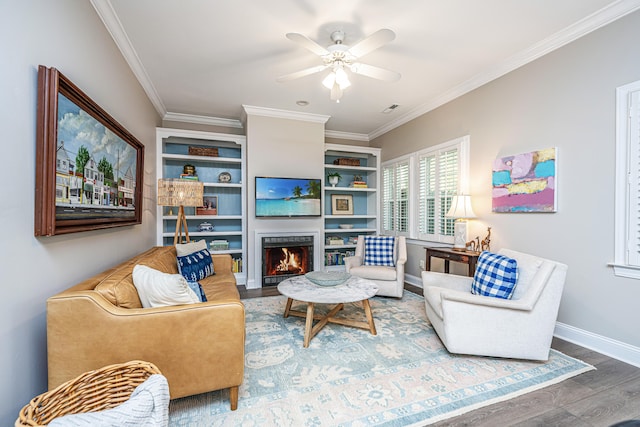 living room featuring hardwood / wood-style flooring, ornamental molding, and ceiling fan