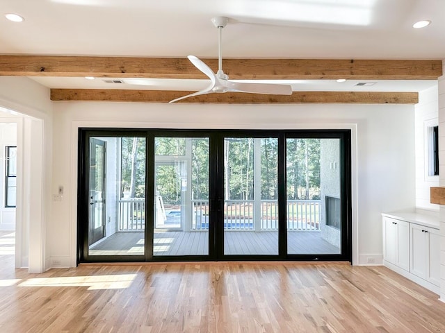 entryway featuring beamed ceiling, ceiling fan, and light hardwood / wood-style floors