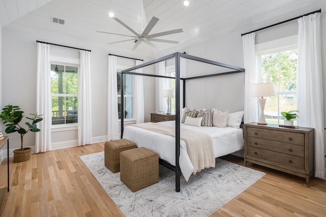 bedroom featuring multiple windows, ceiling fan, and light hardwood / wood-style floors