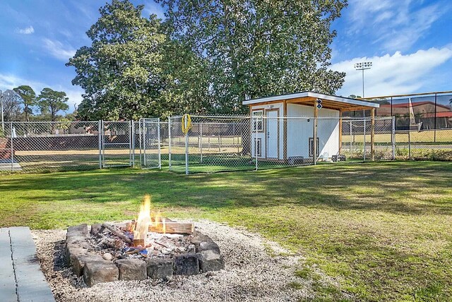 1113 Smithfield Pl, Hanahan, SC 29410 - view of yard with an outdoor structure, fence, and an outdoor fire pit